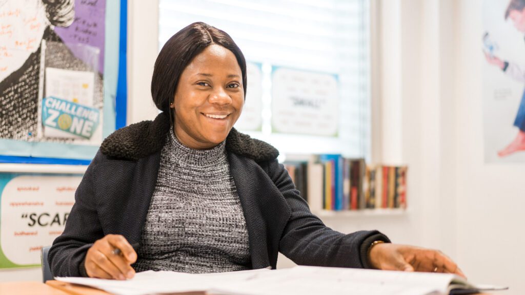 Woman sitting at her desk smiling